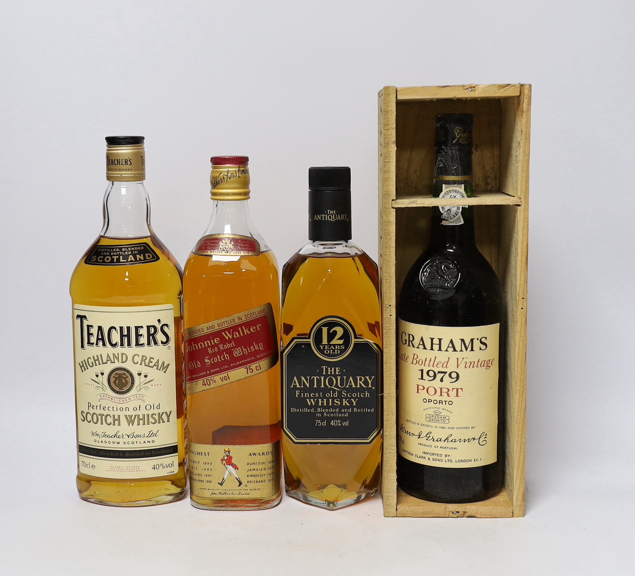 A bottle of The Antiquary Scotch Whisky, a bottle of Teachers and a bottle of Johnnie Walker, plus a cased bottle of Vintage Graham’s 1979 Port